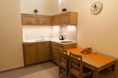 a kitchen with a wooden table and a sink and a counter at Karlova 25 Apartments in Prague