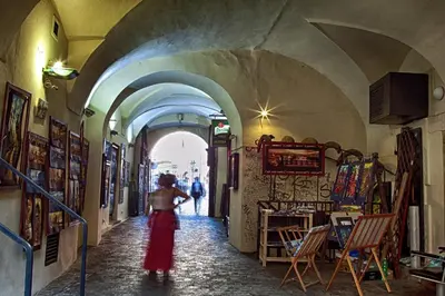 a woman walking down an alley in a building at Karlova 25 Apartments in Prague