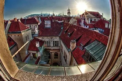 a view of the roofs of a city seen through a mirror at Karlova 25 Apartments in Prague