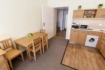a kitchen and dining room with a table and chairs at Karlova 25 Apartments in Prague