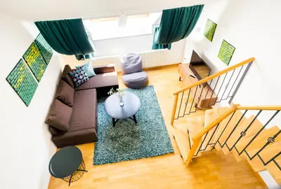 a living room with a couch and a table at HOME ALONE 5BR+3BATH Penthouse in center of Prague in Prague