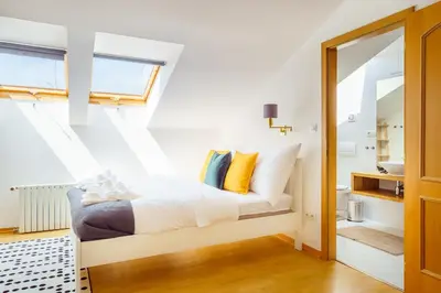 a bedroom with a bed with yellow pillows at HOME ALONE 5BR+3BATH Penthouse in center of Prague in Prague