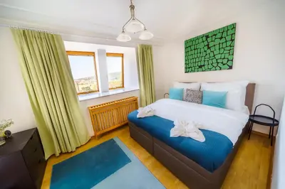 a bedroom with a bed with blue and white at HOME ALONE 5BR+3BATH Penthouse in center of Prague in Prague