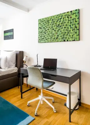a desk with a laptop and a chair in a room at HOME ALONE 5BR+3BATH Penthouse in center of Prague in Prague