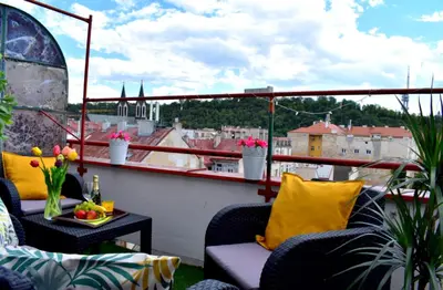 a balcony with couches and a view of a city at Prague city centre apartment Radka1 in Prague