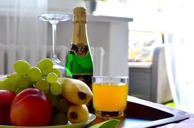a table with a bowl of fruit and a bottle of wine at Prague city centre apartment Radka1 in Prague
