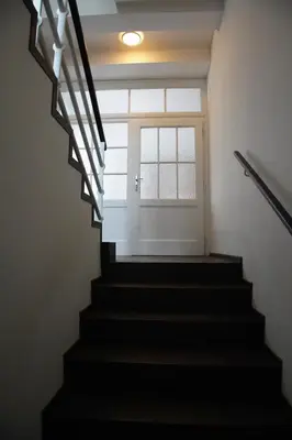 a stairway with a window and a door at APARTMÁN V ZAHRADĚ PRAHA TROJA - APARTMENT IN THE GARDEN PRAGUE Troja in Prague