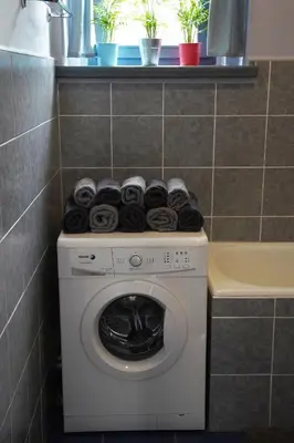 a washing machine with towels on top of it in a bathroom at APARTMÁN V ZAHRADĚ PRAHA TROJA - APARTMENT IN THE GARDEN PRAGUE Troja in Prague