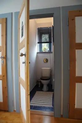 a bathroom with a toilet and a window at APARTMÁN V ZAHRADĚ PRAHA TROJA - APARTMENT IN THE GARDEN PRAGUE Troja in Prague