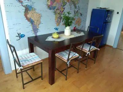 a table and chairs with a map on the wall at APARTMÁN V ZAHRADĚ PRAHA TROJA - APARTMENT IN THE GARDEN PRAGUE Troja in Prague