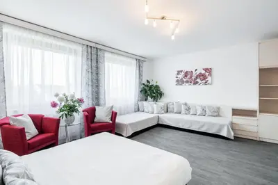 a living room with two beds and two chairs at A.V.E. Pension Kliská in Prague