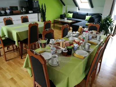 a green table with food on it in a living room at A.V.E. Pension Kliská in Prague