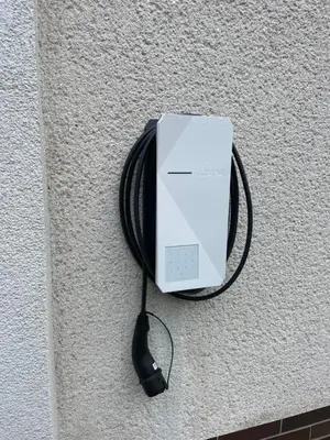 a white ipod plugged into a wall at A.V.E. Pension Kliská in Prague