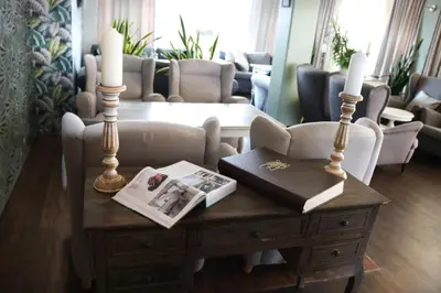 a coffee table with two candles and a book on it at Balu Apartments in Prague