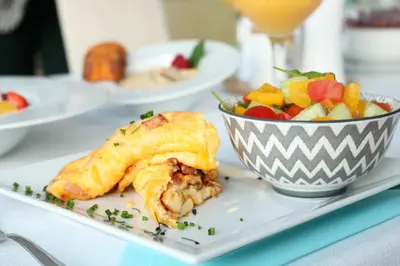 a plate with a pastry and a bowl of fruit at Balu Apartments in Prague