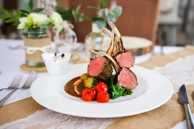 a plate of food with meat and vegetables on a table at Balu Apartments in Prague