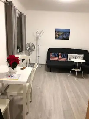 a living room with a couch and a table and chairs at Apartment Happy 11 in Prague