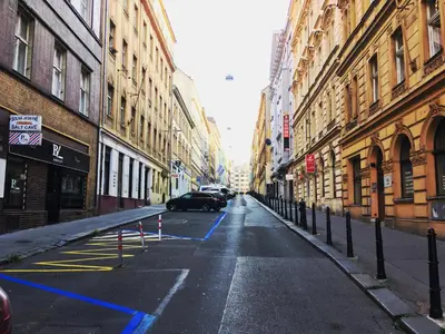 a car driving down a city street with buildings at Apartment Happy 11 in Prague