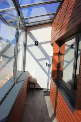 a room with a glass door and a window at Apartments Severka in Prague