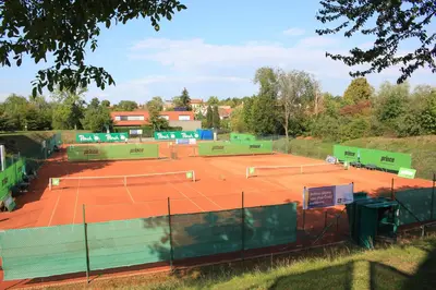 a tennis court with two tennis rackets on it at Apartments Severka in Prague