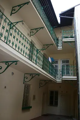 a staircase in a building with green railings at Apartment No 0A Anenska 13 - Stare Mesto in Prague