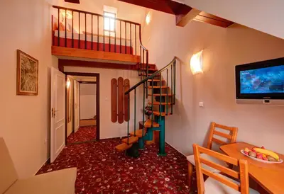 a hallway with a spiral staircase in a house at Park Hotel Pruhonice in Pruhonice