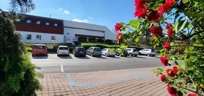a parking lot with cars parked in front of a building at Park Hotel Pruhonice in Pruhonice