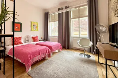 a bedroom with a bed with a pink blanket at No1 Style & Design XXL City Centre Apartment in Prague