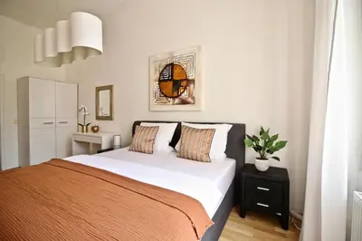 a bedroom with a bed and a potted plant at No1 Style & Design XXL City Centre Apartment in Prague