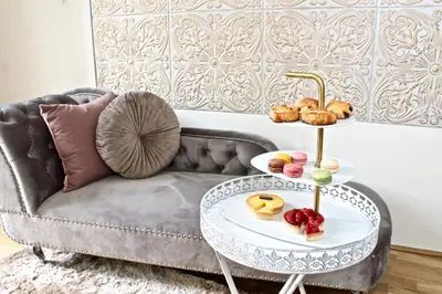 a living room with a couch and a table with food on it at No1 Style & Design XXL City Centre Apartment in Prague