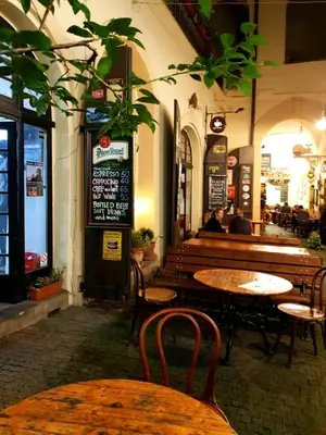 a restaurant with wooden tables and chairs and a bench at No1 Style & Design XXL City Centre Apartment in Prague