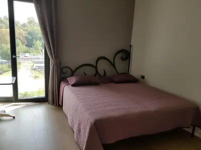 a bedroom with a bed and a large window at Praha Karibik in Prague