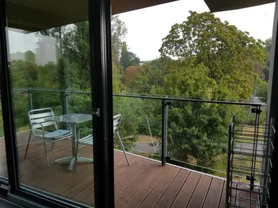 a balcony with a table and chairs on a deck at Praha Karibik in Prague
