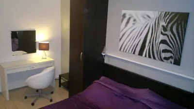 a bedroom with a painting of a zebra on the wall at Hotel Terek in Štětí