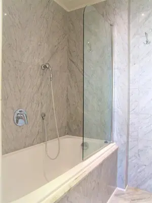 a shower with a glass door in a bathroom at Charles Bridge Suites in Prague