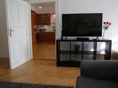 a living room with a flat screen tv on a stand at Charles Bridge Suites in Prague