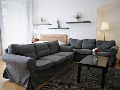 a living room with a couch and a table at Charles Bridge Suites in Prague