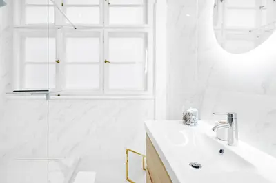 a white bathroom with a sink and a shower at Palace Dlouhá Apartments - Old Town in Prague