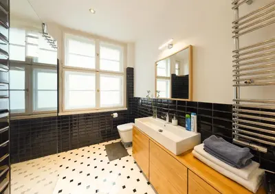 a bathroom with a sink and a toilet and a mirror at Palace Dlouhá Apartments - Old Town in Prague