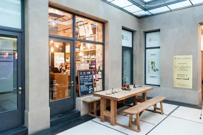 a table and benches in front of a restaurant at Palace Dlouhá Apartments - Old Town in Prague