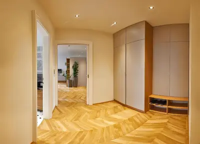 an empty room with wood floors and cabinets at Palace Dlouhá Apartments - Old Town in Prague