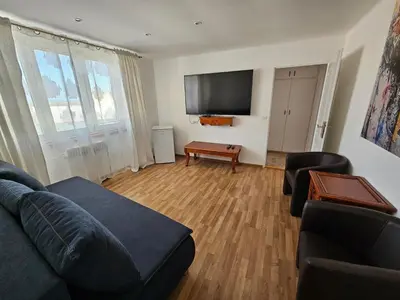 a living room with a couch and a table at Hotel Union in Louny