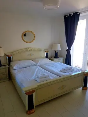 a large bed in a bedroom with a window at Hotel Union in Louny