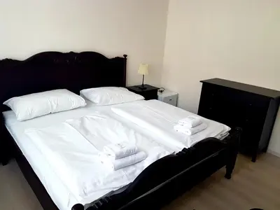 a bedroom with a large bed with white sheets and towels at Hotel Union in Louny