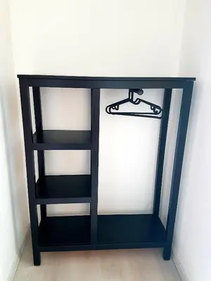 a black book shelf against a white wall at Hotel Union in Louny