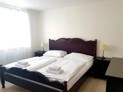 a bedroom with a large bed with towels on it at Hotel Union in Louny