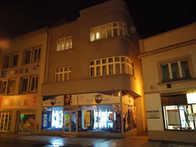 a building at night with lights on at Apartmány Rossa in Louny