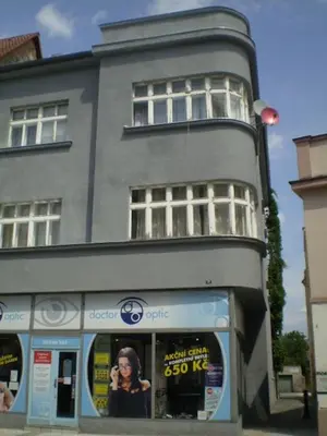 a building with a sign in the window of a store at Apartmány Rossa in Louny