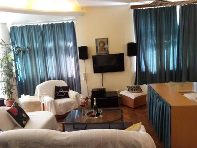 a living room with white furniture and a tv at Apartmány Rossa in Louny