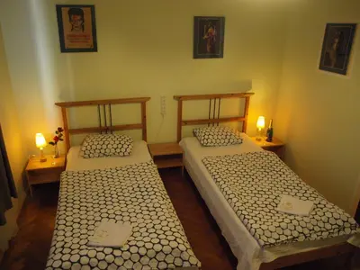 two beds in a small room with two lamps at Apartmány Rossa in Louny